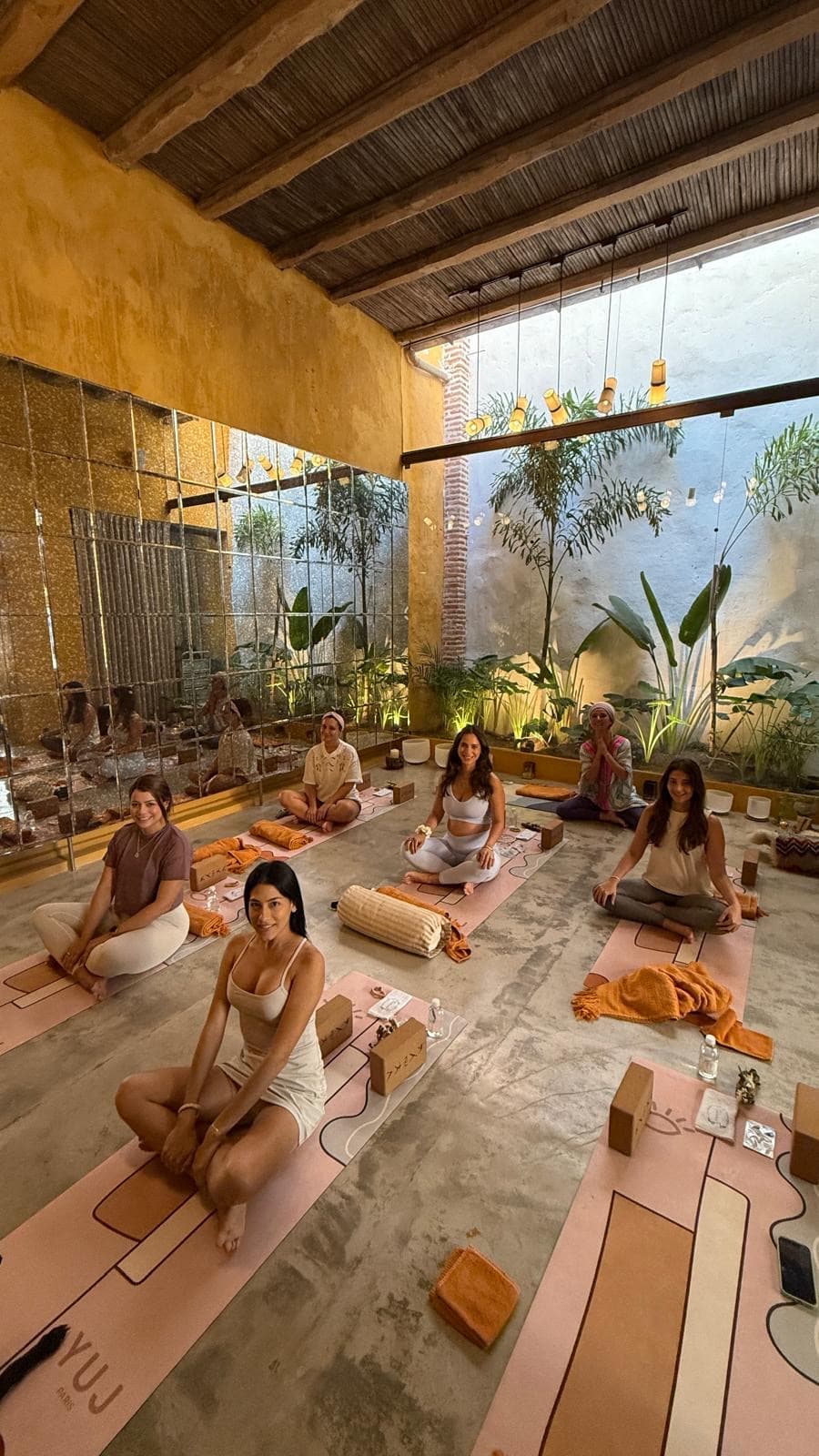 Group yoga class at Casa Carolina Cartagena — JustbYoga by TUISYOU daily wellness classes with sound bowls and mats